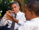 A close-up of George Clooney as he listens to President Barack Obama who is out-of-focus in the bottom of the image. The two are discussing the ethics of using machine learning to aid the Sudanese.