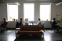 two employees at Azavea sitting at desks