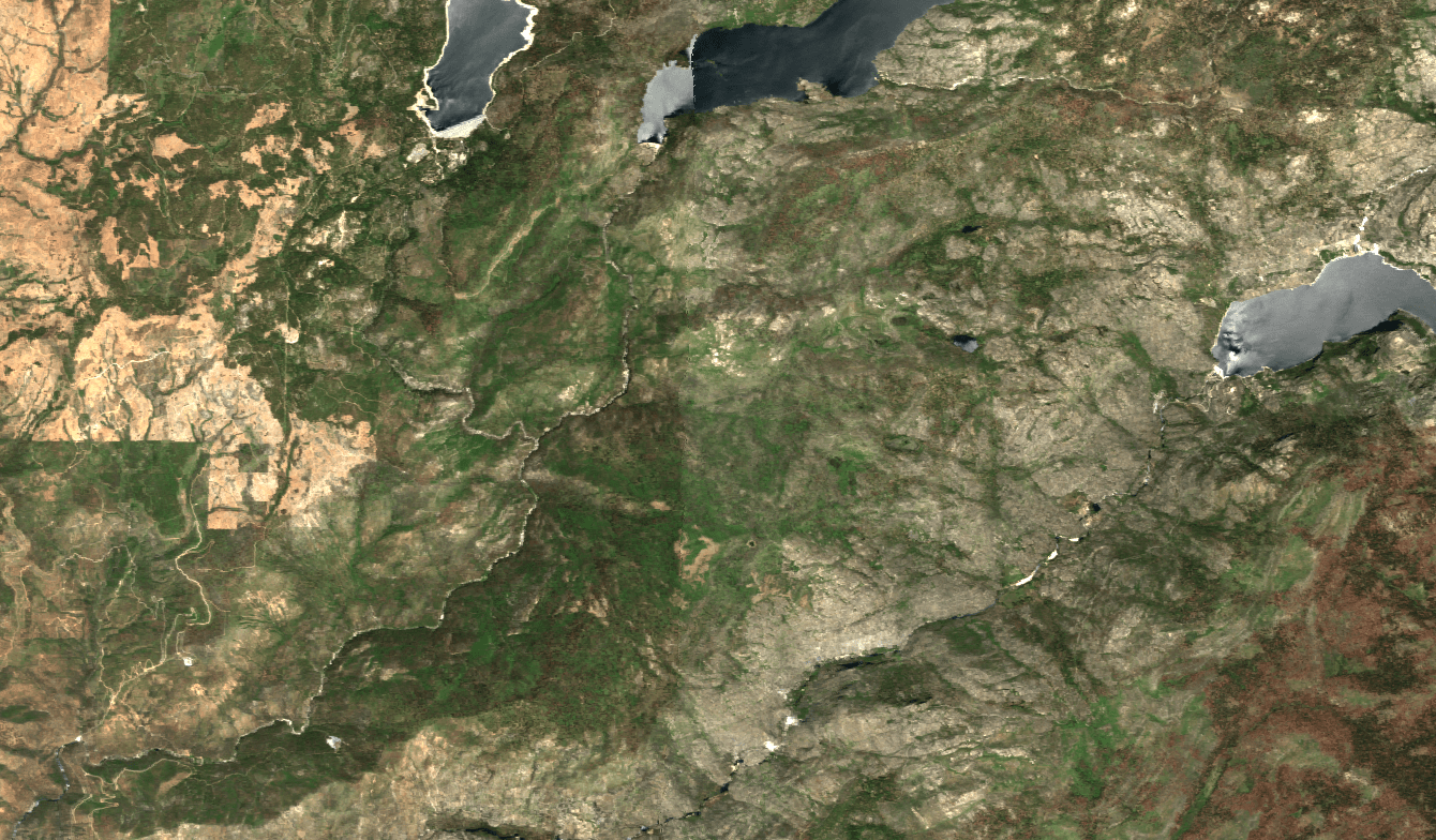 An aerial image of a mountainous area with three bodies of water
